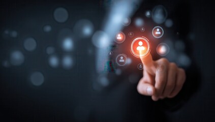 Businessman touching a virtual screen with a customer avatar icon and social media icons on a hologram interface for marketing or business strategy planning, against a dark.
