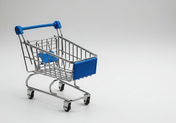 Miniature shopping cart with blue accents on a plain background