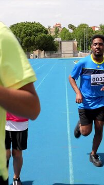 Athletes running on blue track during competition