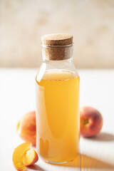 Refreshing peach kombucha tea in a glass bottle. Healthy drink