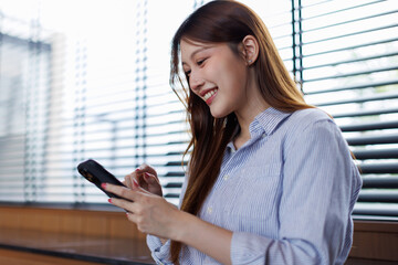 Beautiful Asian female has transfer money financial internet banking on mobile phone, asian woman...