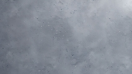 A close up view of a gray concrete surface with small dark and light speckles scattered across it