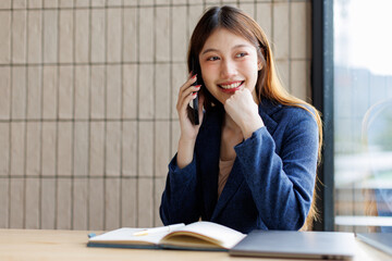 Smiling happy asian call center agent talking to client, contract service telemarketing operator...