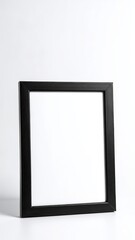 A sleek black frame elegantly contrasts against a pristine white background, highlighting its modern design and creating a striking visual appeal.