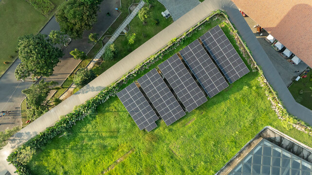Aerial View of Eco-Friendly Solar Panels on Green Roof Integrated with Urban Landscape Design