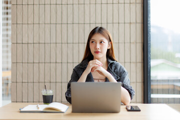 Happy young asian girl learn english language online with computer laptop.discussing a project, and...