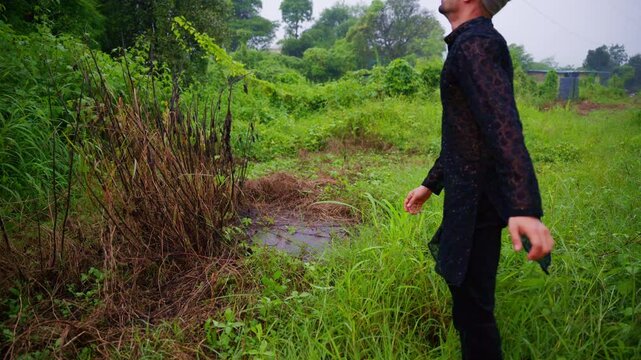 Muslim man in wilderness pulls out grass into rage