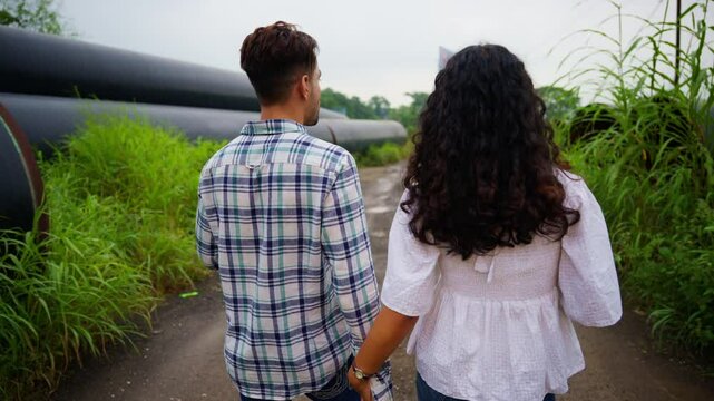 Lovers Enjoy Scenic Countryside Date Near Giant Pipes