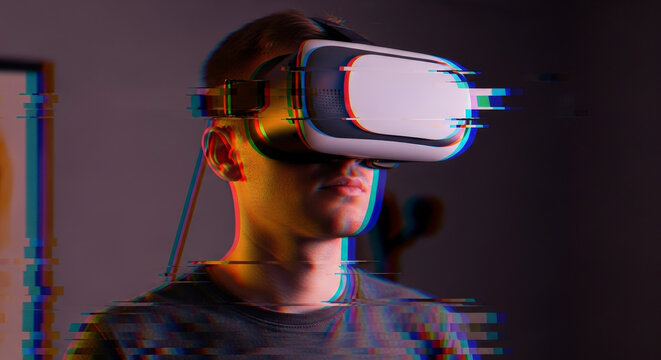 Man Wearing Virtual Reality Headset with Digital Glitch Effect in Dark Setting