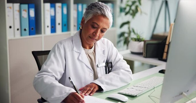 Doctor, computer and mature woman writing notes for prescription, health report or research. Clinic, paper or medical professional with healthcare information, schedule or check results for diagnosis