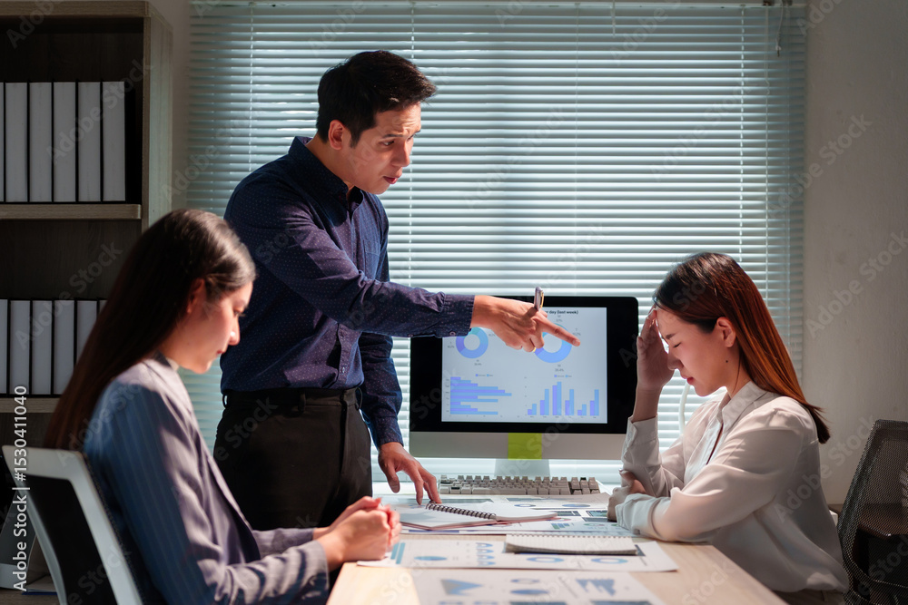 Poster asian manager pointing at computer screen showing declining statistics and scolding frustrated emplo