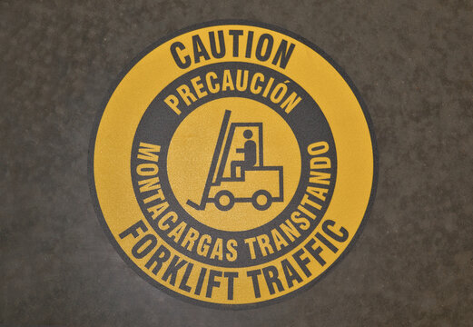 Caution Forklift Traffic sticker on warehouse floor warning safety signs.