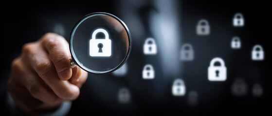 A hand holds a magnifying glass focusing on a digital padlock icon, symbolizing cybersecurity and data protection.
