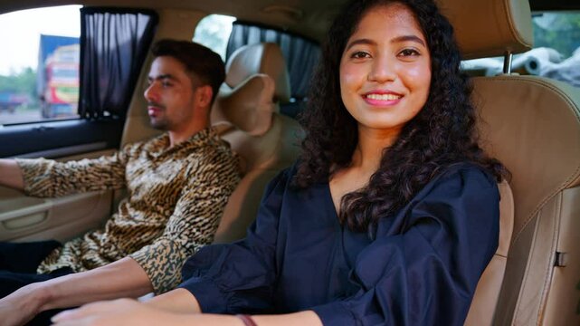 Romantic couple sits inside car during holiday time