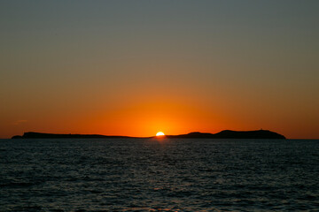 Fototapeta premium Beautiful sunset from Cafe Mambo in San Antonio Bay on the island of Ibiza in summer.