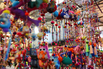 Vibrant collection of handcrafted ornaments hanging in a store.