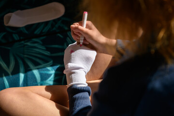 Making sock puppets with a marker pen. View from above.