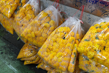 Vibrant Yellow Flowers Beautifully Arranged in Market Bags for Sale.