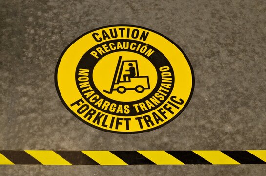 Caution Forklift Traffic sticker tape on warehouse floor warning safety signs. - Powered by Adobe