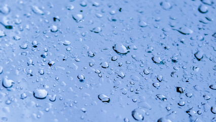 Gentle Drops: A serene macro shot capturing the delicate beauty of water droplets clinging to a smooth surface, reflecting light and texture