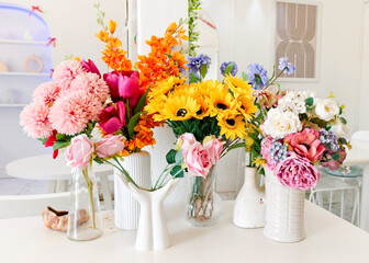 Floral Symphony: A vibrant assortment of meticulously arranged artificial flowers bursts forth in a radiant display, each bloom carefully positioned to create an enchanting tableau.