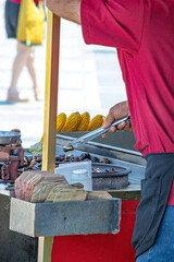 Famous street vendors of Istanbul Türkiye. Seller of roasted chestnuts and corn. Faceless man. Vertical photo.