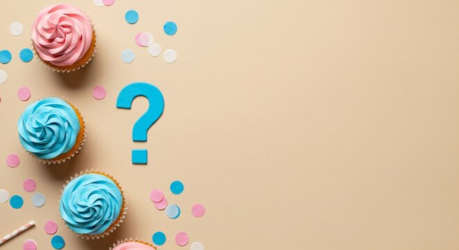 Pink and blue cupcakes with a question mark. Gender reveal concept for baby shower party or new baby announcement.