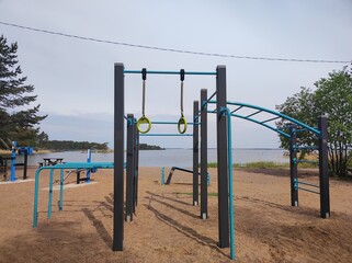 Fototapeta premium Sports ground on a sandy beach on the seashore, strength training equipment
