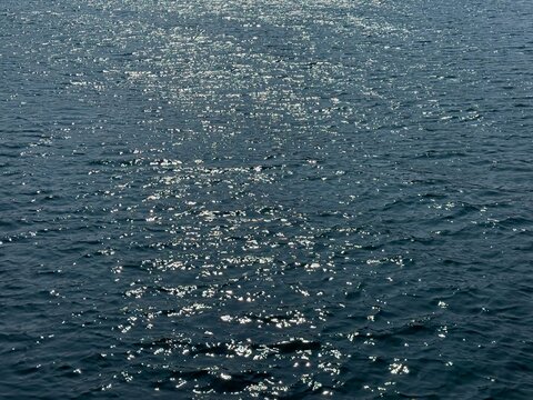 Ocean shiny blue navy waves background.