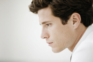 portrait of financial advisor with calculating expression positioned on right side of frame