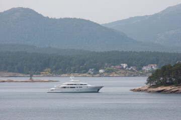 Obraz premium luxurious yacht floating serenely on calm waters surrounded by pristine natural landscape