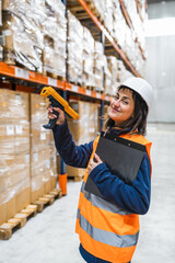 Warehouse worker scanning packages using barcode reader, managing inventory and logistics in a distribution center