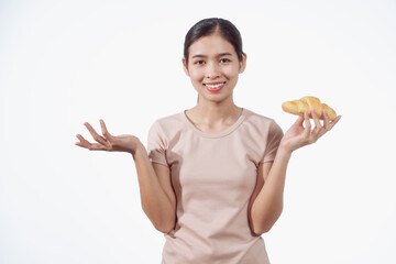 A confident young Asian woman in a light brown shirt stands against a white background, happily...