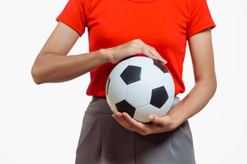 Confident young Asian woman in vibrant red shirt stands against white background, cheering joyfully...