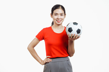Confident young Asian woman in vibrant red shirt stands against white background, cheering joyfully...