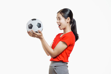 Confident young Asian woman in vibrant red shirt stands against white background, cheering joyfully...