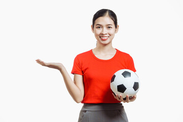 Confident young Asian woman in vibrant red shirt stands against white background, cheering joyfully...