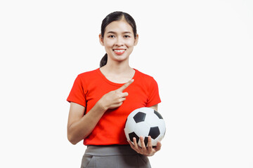 Confident young Asian woman in vibrant red shirt stands against white background, cheering joyfully...