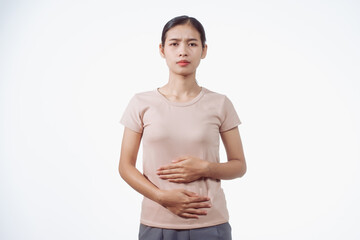 A confident young Asian woman in a light brown shirt stands against a white background,...