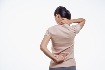 A confident young Asian woman in a light brown shirt stands against a white background, suffering...