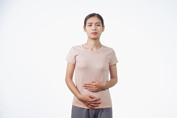 A confident young Asian woman in a light brown shirt stands against a white background,...