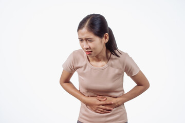 A confident young Asian woman in a light brown shirt stands against a white background,...