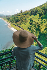 Female Explorer Looking at Ocean Horizon from Cliff