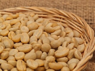 Green coffee beans in basket.