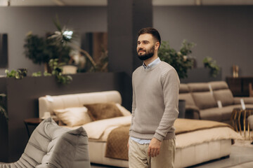 Man Exploring Modern Furniture Display in a Stylish and Contemporary Store Interior