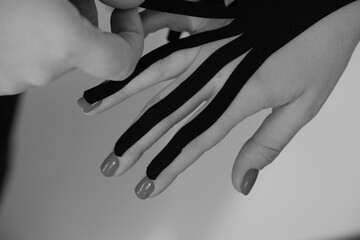 Kinesiology tapes on a girl's wrist. Fingers wrapped in tape.