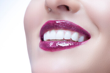 Fototapeta premium Extreme Closeup of Cute Winsome Blond Woman Lips as Model Girl with Perfect Fresh Clean Skin Looking With Smile as Skin Care Concept Isolated on Pure White.