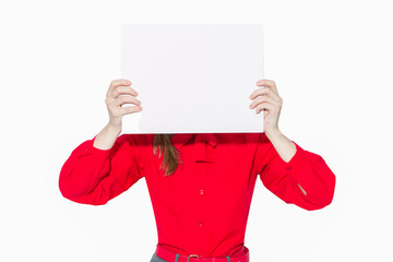 One Caucasian Business Woman in Red Shirt Holding White Empty Card Board While Hiding Face Behind Card Isolated On White