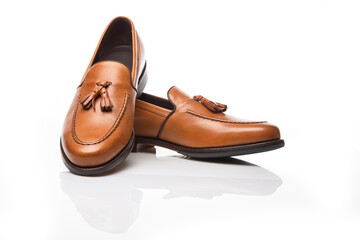 Mens Footwear Concepts. Pair of Traditional Formal Stylish Light Brown Polished Calf Leather Tassel Loafer Shoes On White Seamless Surface.