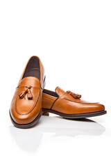 Mens Footwear Concepts. Pair of Traditional Formal Stylish Light Brown Polished Calf Leather Tassel Loafer Shoes On White